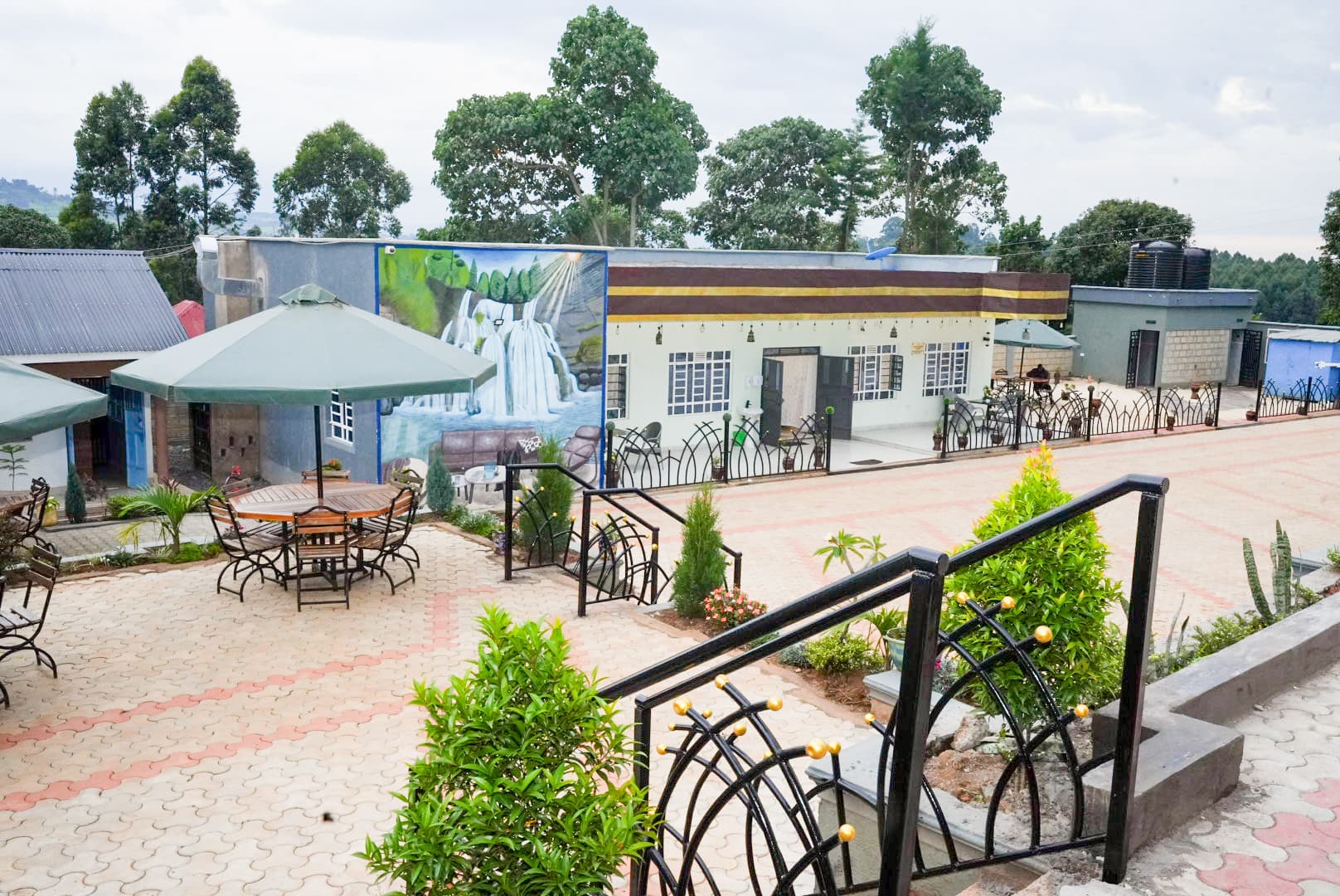 Boutique highland hotel exterior with deep veranda and landscaped gardens at golden hour